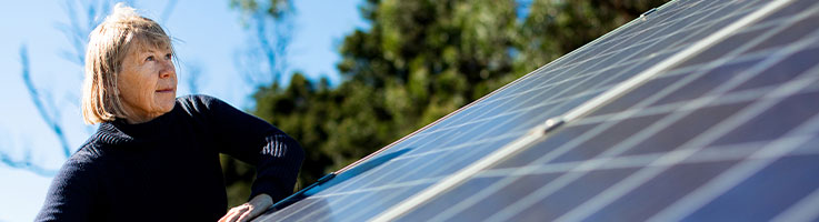 woman checking angle of solar panels