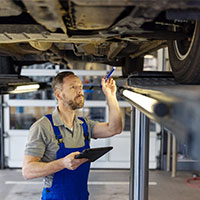 auto mechanic inspecting car