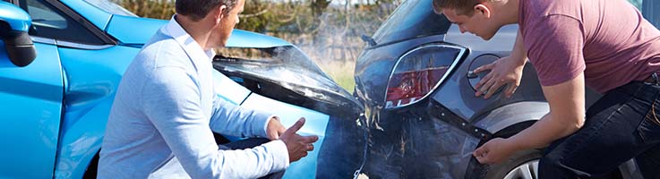 two men examining fender bender accident