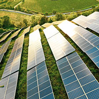 aerial view of solar panels on green hills