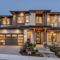 a two-storey house with the lights on early at night