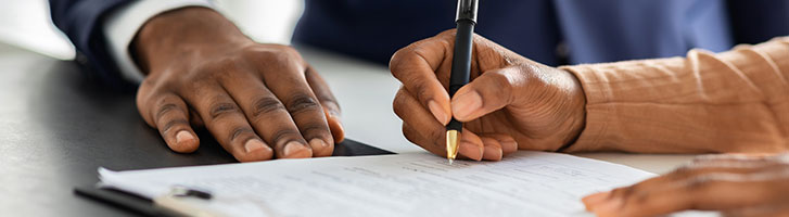 customer signing a contract in front of representative