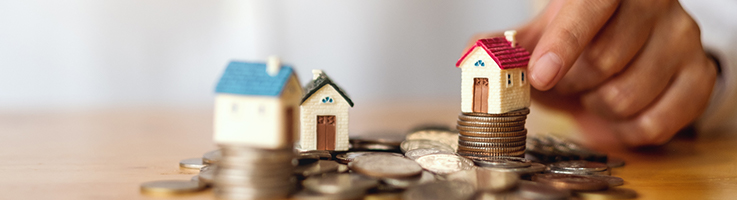 houses sitting on top of coins