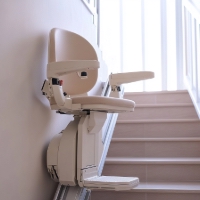 a stairlift parked at the bottom of narrow stairs