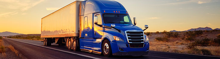 blue moving truck on desert highway