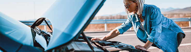 woman checking car engine