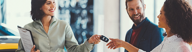 woman getting keys to new car