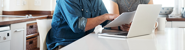 man and woman looking at document