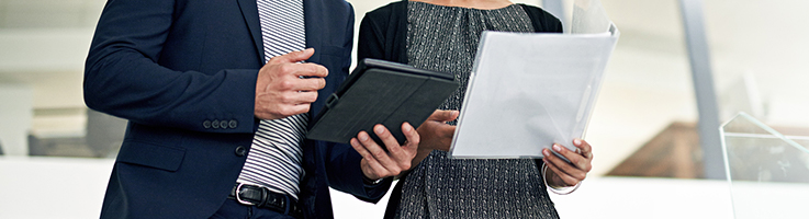 man and woman looking at documents