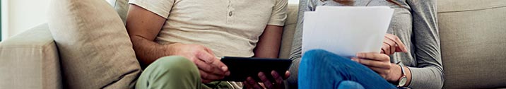 Couple looking at bills on couch