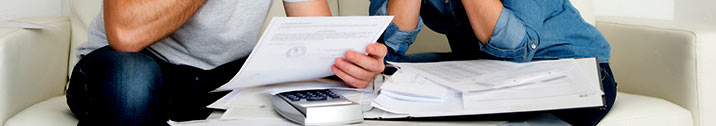 Couple looking at stack of bills