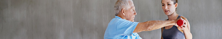 Elderly man lifting hand weight