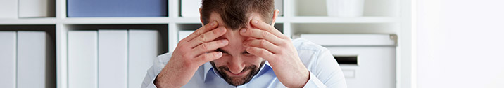 Frustrated man holding head