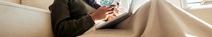 Girl under blanket on phone