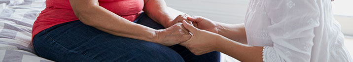 Woman holding hands with senior