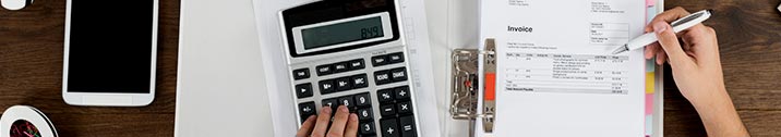 Invoices and calculator on desk