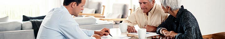 Lawyer sitting with older couple