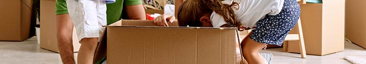 Little girl with moving box