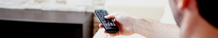 Man changing channel with remote