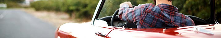 Man driving red sports car
