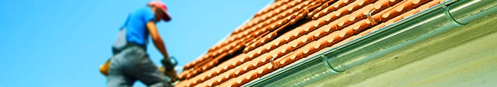 Man on roof of house