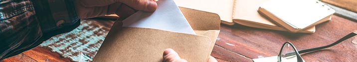 Man opening up mail envelope