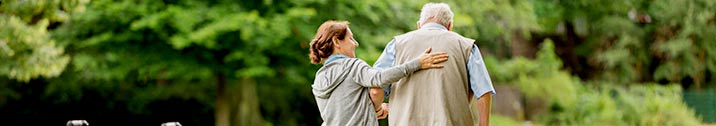 Nurse helping senior patient walk