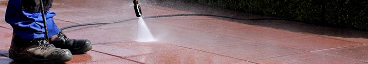 Pressure washing deck with boots on