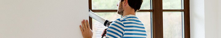 Man sealing windows