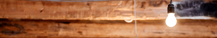 Single lightbulb on wood ceiling