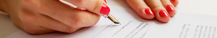 Woman signing a paper