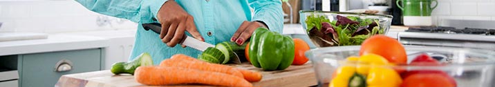 Woman slicing fruits and veggies