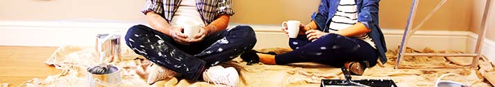 Couple painting room in home