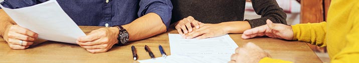Couple reviewing documents with lender