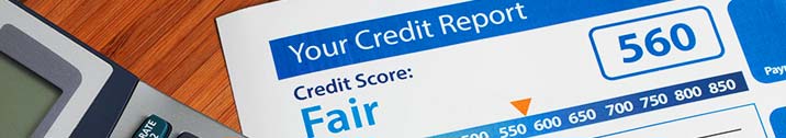 Credit report and calculator on table