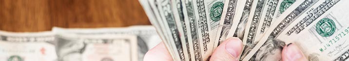 Person holding a stack of cash