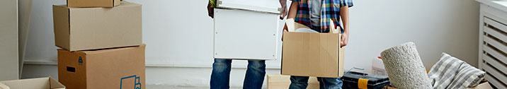 Kid and dad holding moving boxes