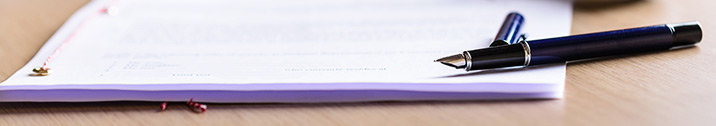 Legal document with pen on a wood table