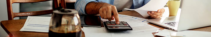 Man calculating costs with calculator