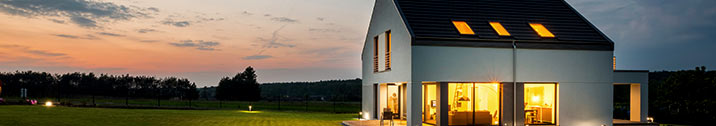 Modern house exterior with lights on