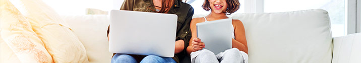 Mom and daughter using laptop and touchpad