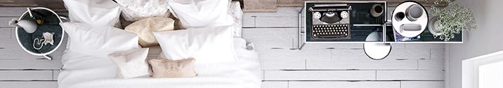 Neutral toned pillows on bed