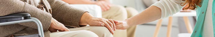 Nurse supporting senior man