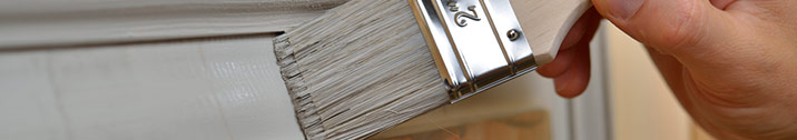 Person painting door gray