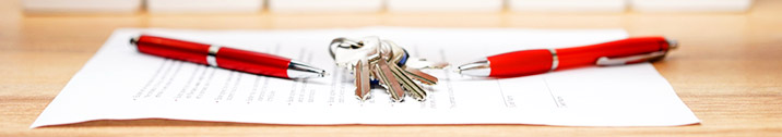 Red pens with keys and paper