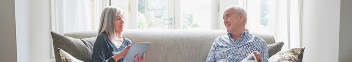 Senior couple sitting on sofa at home