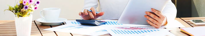 Woman with calculator and documents