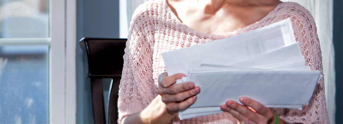 Woman with stack of bills