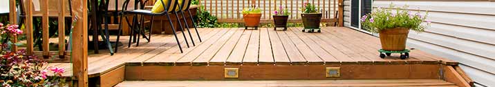 Wooden backyard deck with flowers and furniture