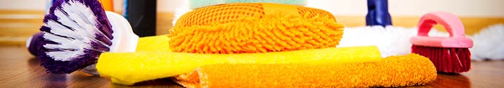 Yellow sponges and towels on wooden floor